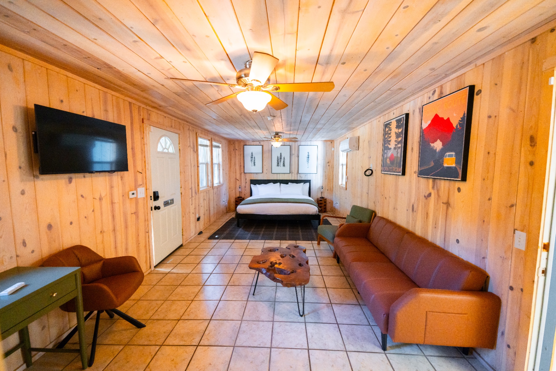 Open living area with sofa, coffee table, and bedroom beyond