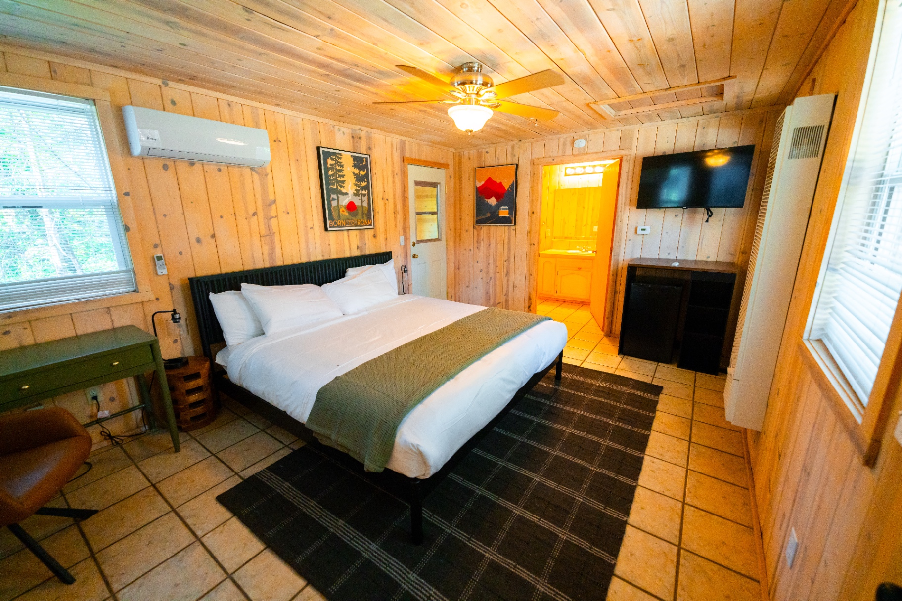 King bedroom with TV, desk, and ensuite bath